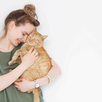 woman holding pet cat